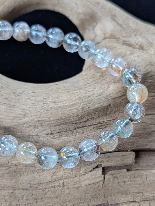 Close-up of 7mm Light Garden Quartz (Lodolite) Bracelet, highlighting individual bead clarity and mineral landscapes.