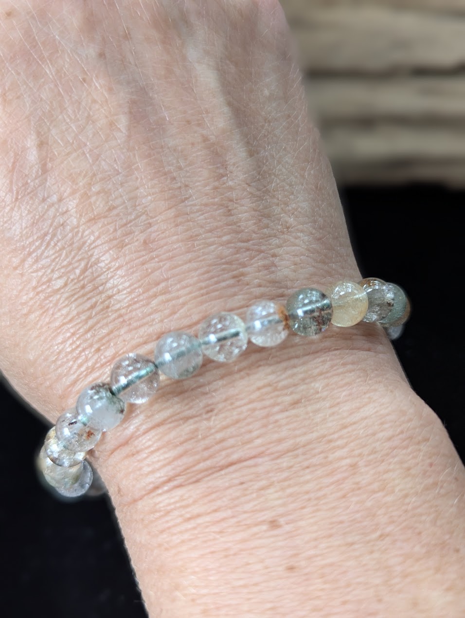 7mm Light Garden Quartz (Lodolite) Bracelet shown worn on a wrist.