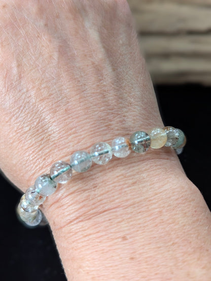 7mm Light Garden Quartz (Lodolite) Bracelet shown worn on a wrist.