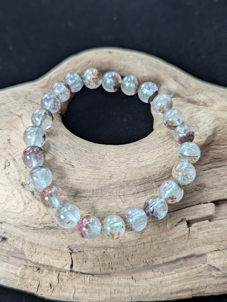 8mm Light Garden Quartz (Lodolite) Bracelet, showcasing earthy green and red inclusions on driftwood.