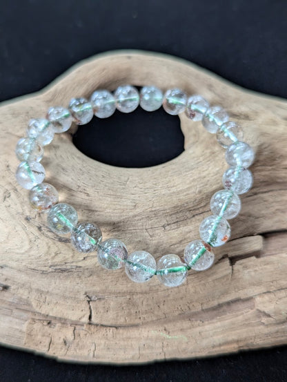 9mm Light Garden Quartz (Lodolite) Bracelet, showing translucent quartz and natural landscapes on driftwood.