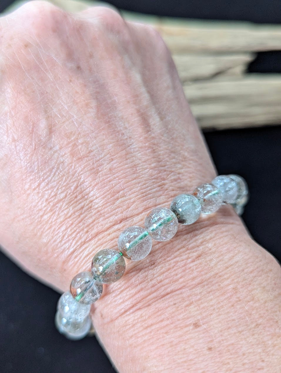 9mm Light Garden Quartz (Lodolite) Bracelet shown worn on a wrist.