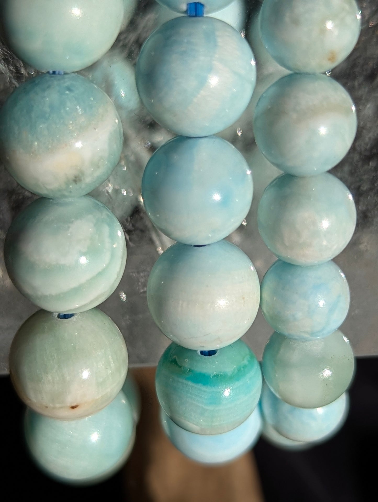 A selection of premium blue hemimorphite bracelets displayed together, showcasing the consistent quality and high transparency across the lot.