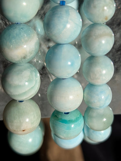 A selection of premium blue hemimorphite bracelets displayed together, showcasing the consistent quality and high transparency across the lot.