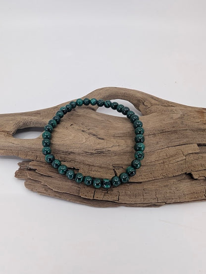 Natural 5mm Malachite bracelet showing vivid green banding and polished finish
