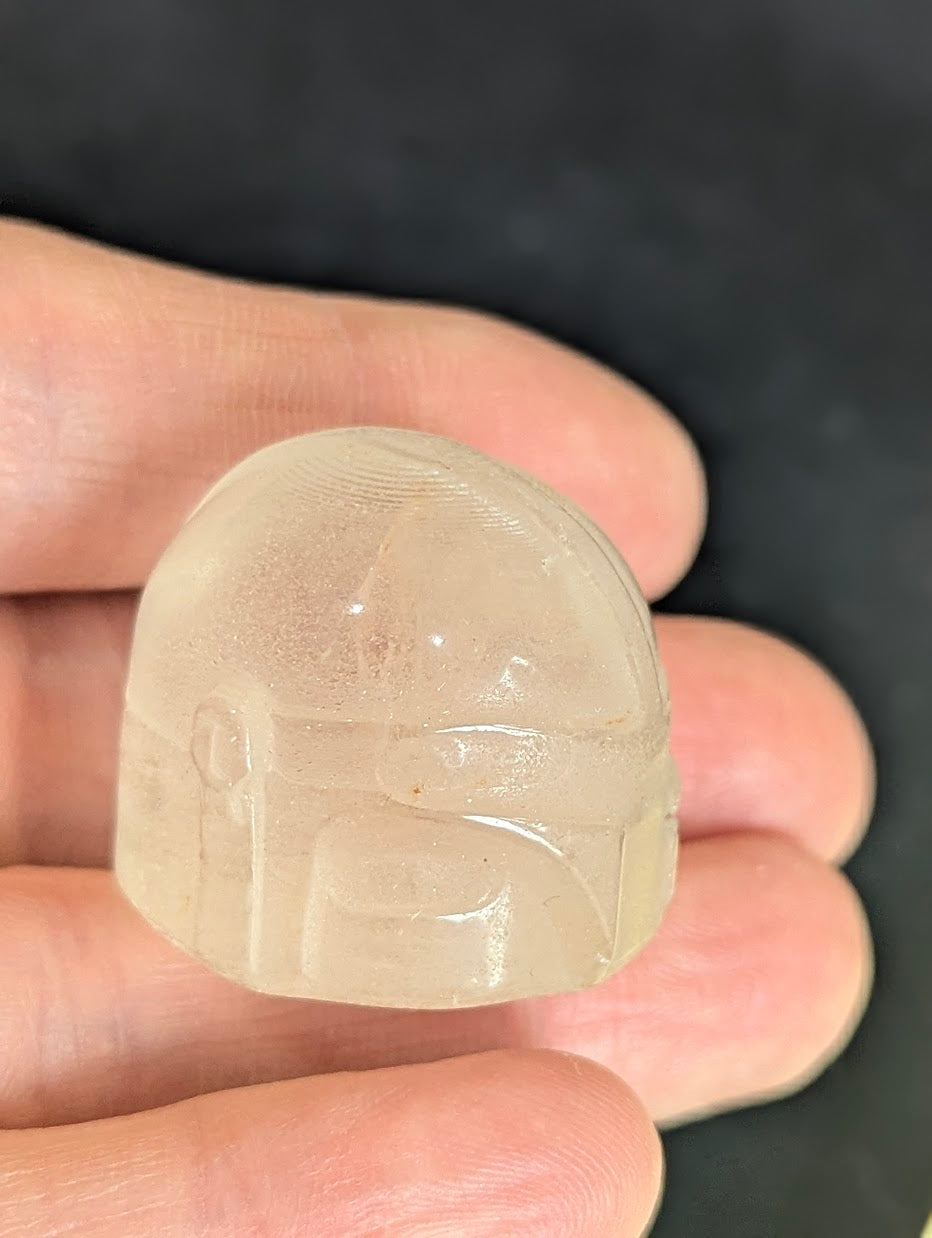 Angled top view of a Clear Quartz Mandalorian helmet showing the precision-carved details.