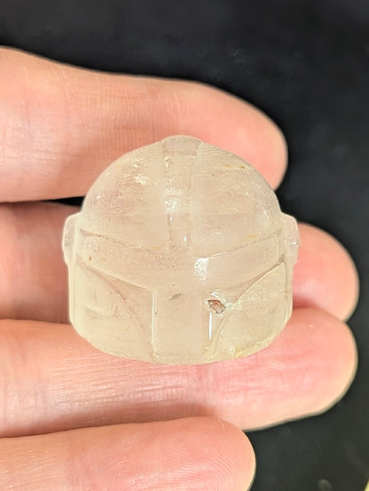Front view of a 3cm Mandalorian helmet carved from natural Clear Quartz.