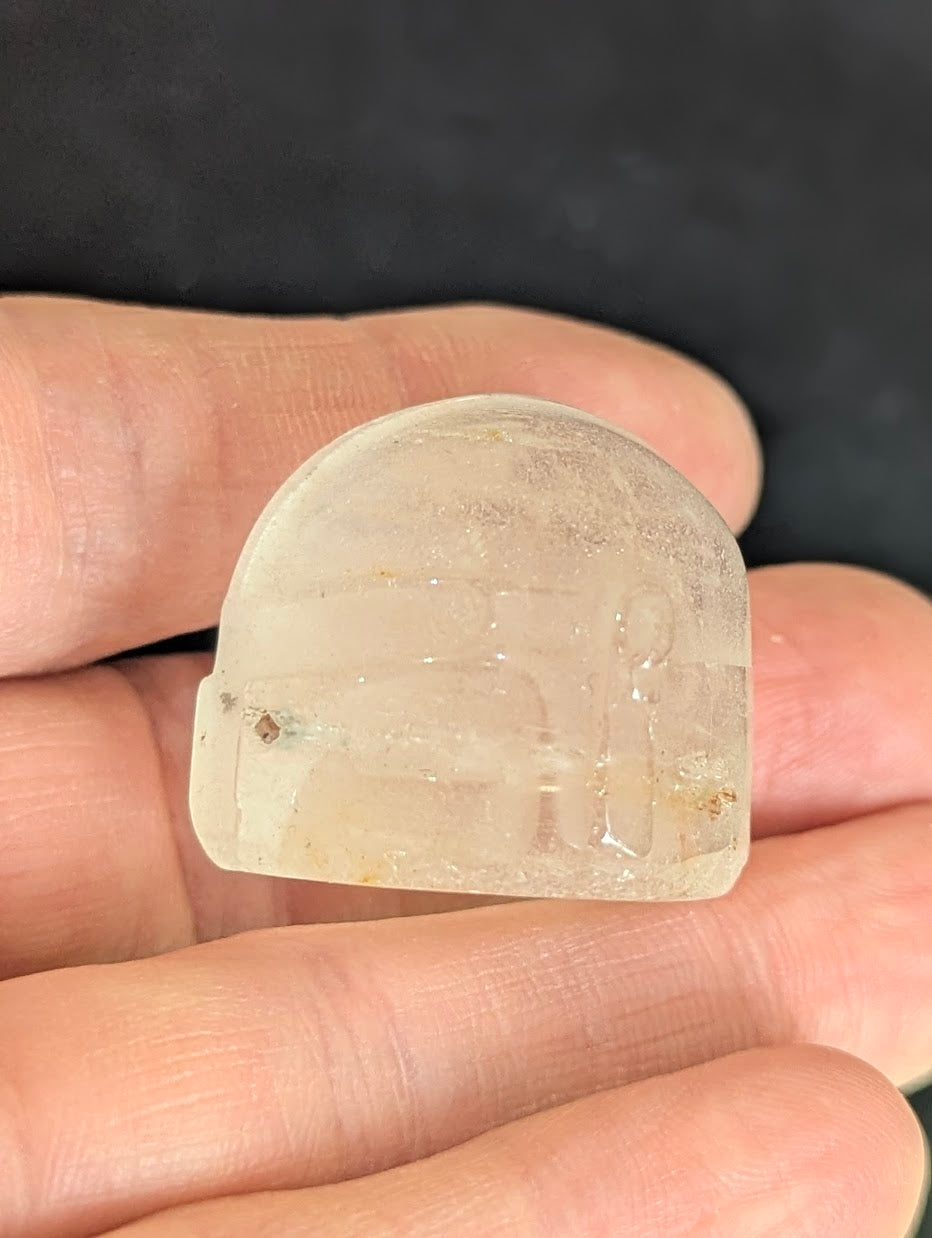 Side profile of a Clear Quartz Mandalorian helmet held in hand.
