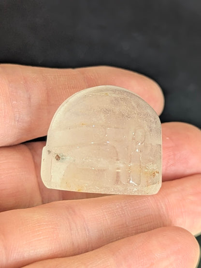 Side profile of a Clear Quartz Mandalorian helmet held in hand.