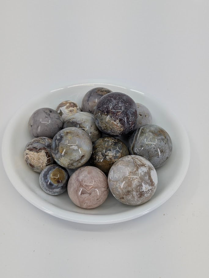 Mexican Lace Agate mini spheres in a bowl showing neutral lace banding