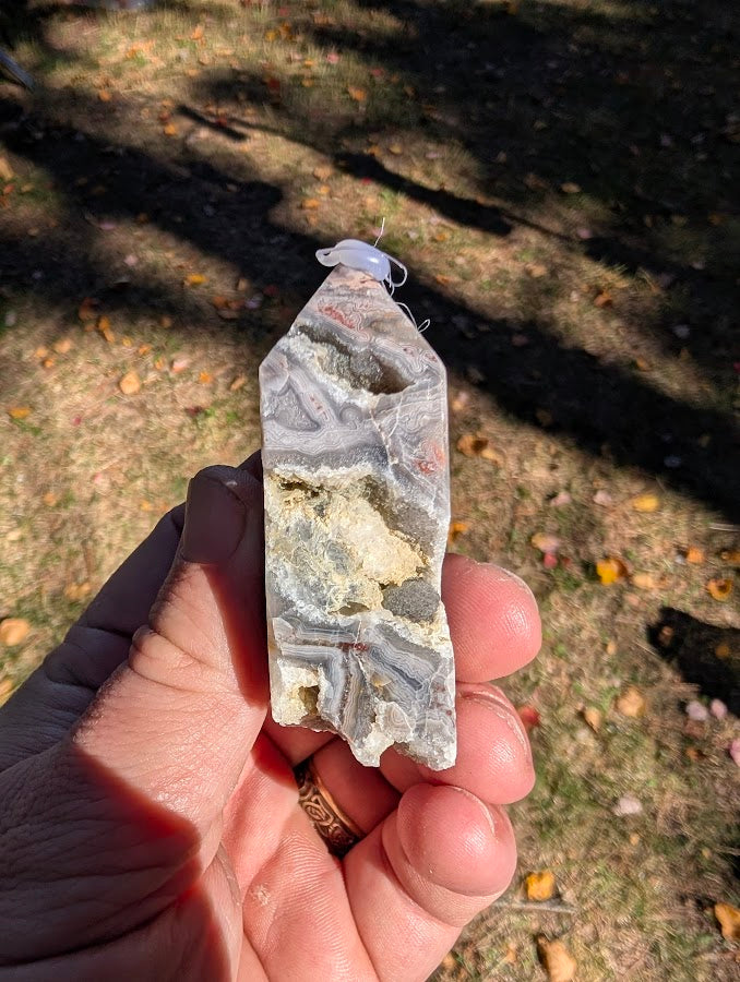 Mexican Lace Agate Tower #2 angled view — intricate banding and natural quartz vugs