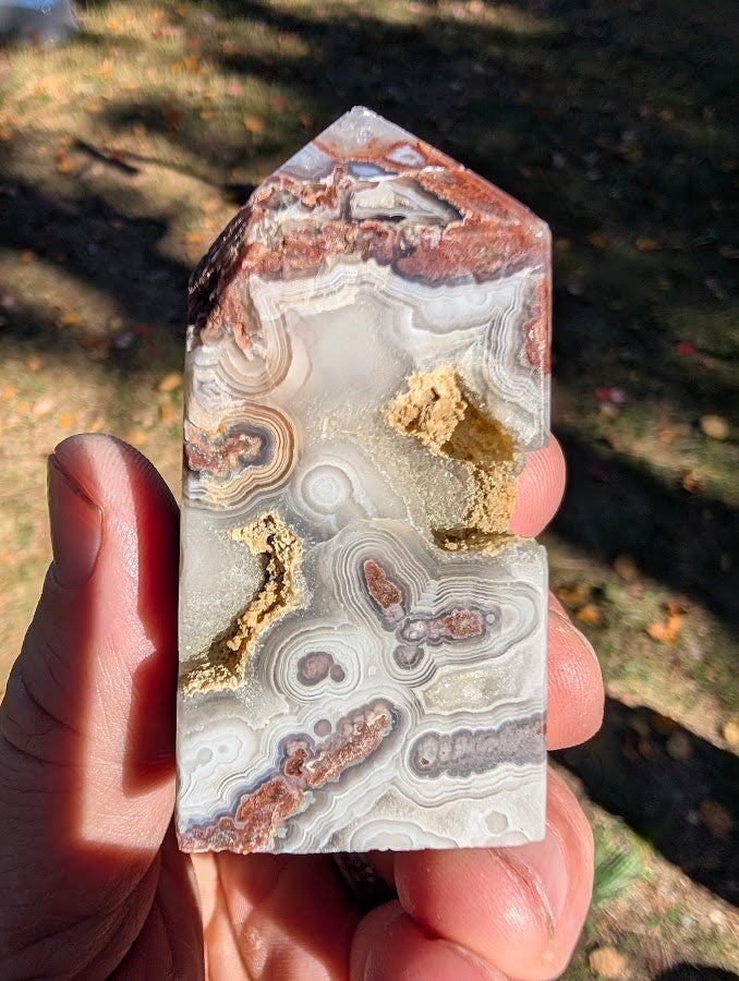 Mexican Lace Agate Tower #3 back view — polished agate with bold lace patterns and open cavities