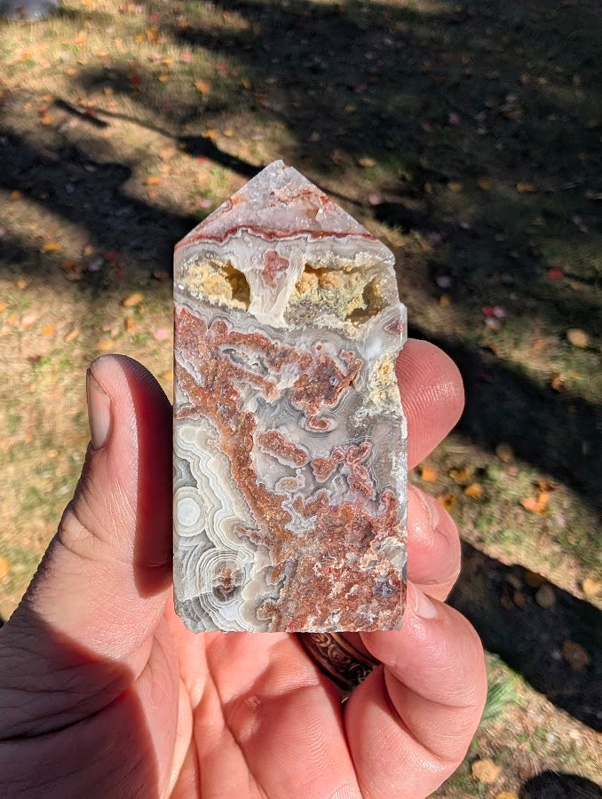 Mexican Lace Agate Tower #3 front view — 68 mm polished tower with red–grey lace banding and quartz vugs