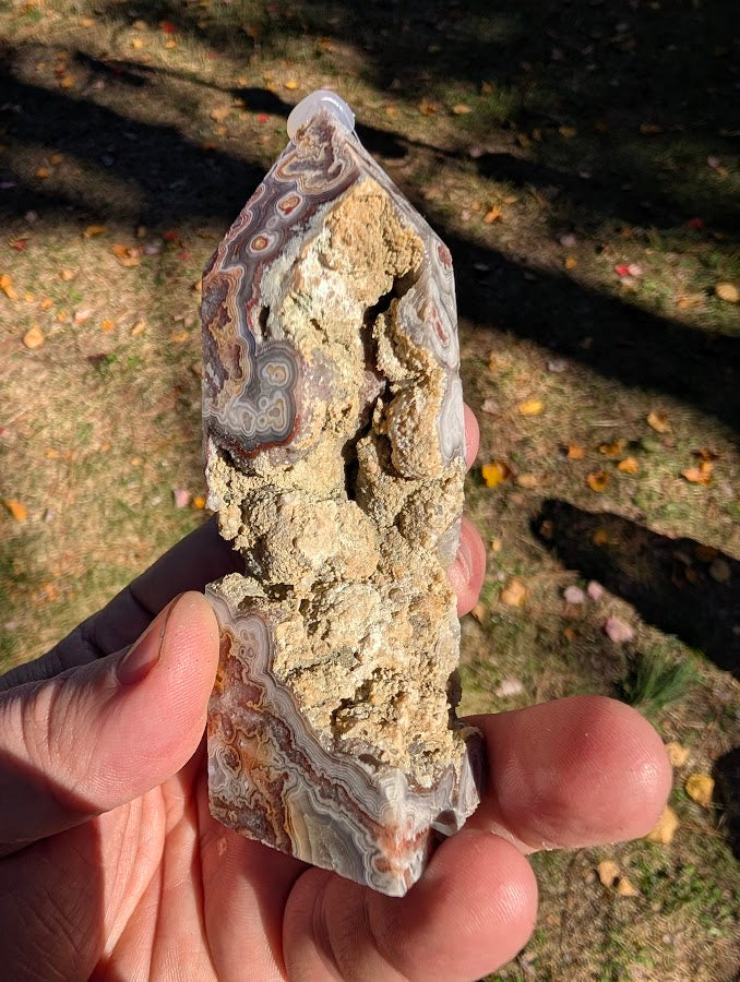 Mexican Lace Agate Tower #6 angled cavity view — textured matrix, quartz pockets, and lace banding