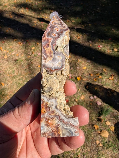 Mexican Lace Agate Tower #6 side view — polished banding contrasted with raw vug and matrix