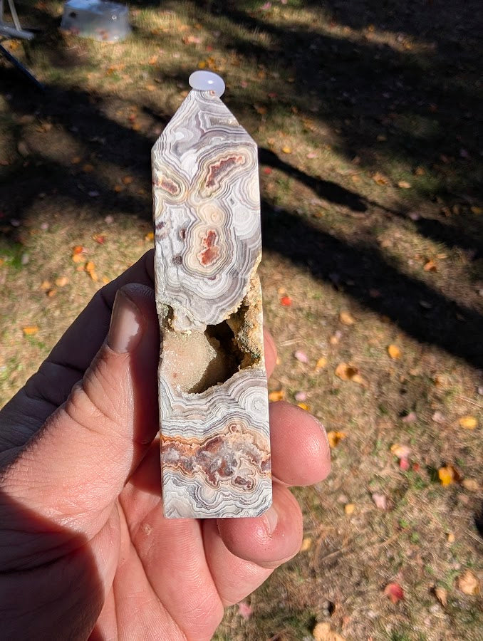 Mexican Lace Agate Tower #7 cavity side — polished bands contrasted with open quartz-lined vug