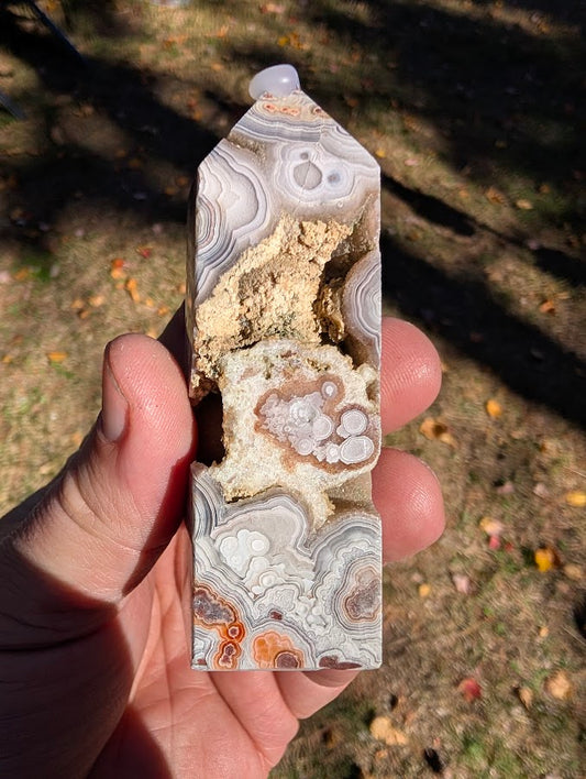 Mexican Lace Agate Tower #7 front view — 90 mm polished agate with large open vug and orbicular bands