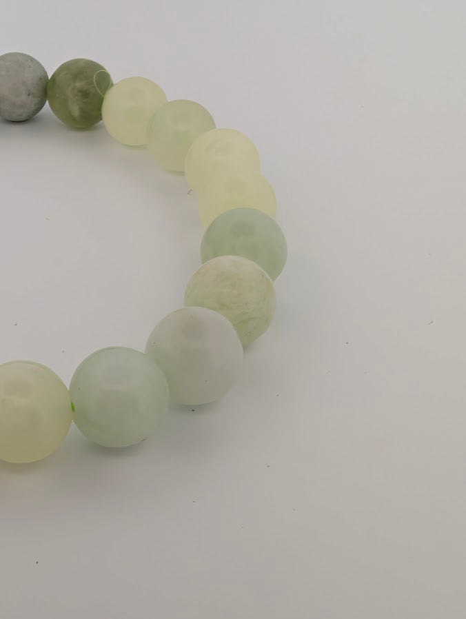 Detail of pastel green Milk Jade bracelet with polished round beads