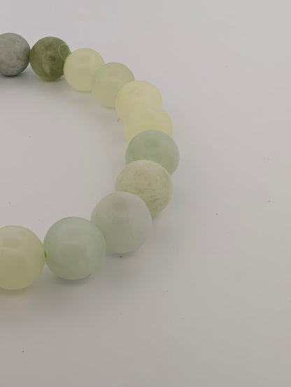Detail of pastel green Milk Jade bracelet with polished round beads