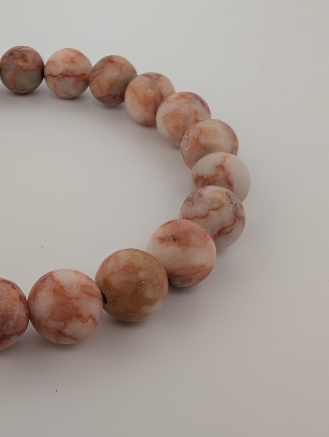 Angled macro shot showing veining in Red Vein Jasper 8mm bracelet