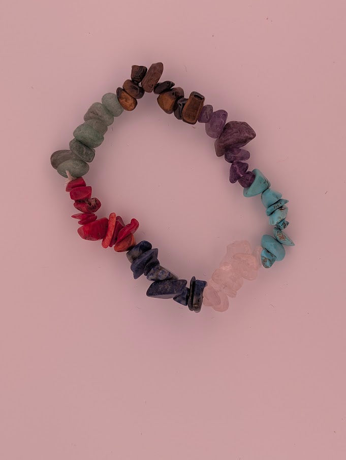 Top-down view of mixed crystal chip bracelet arranged in rainbow colour order