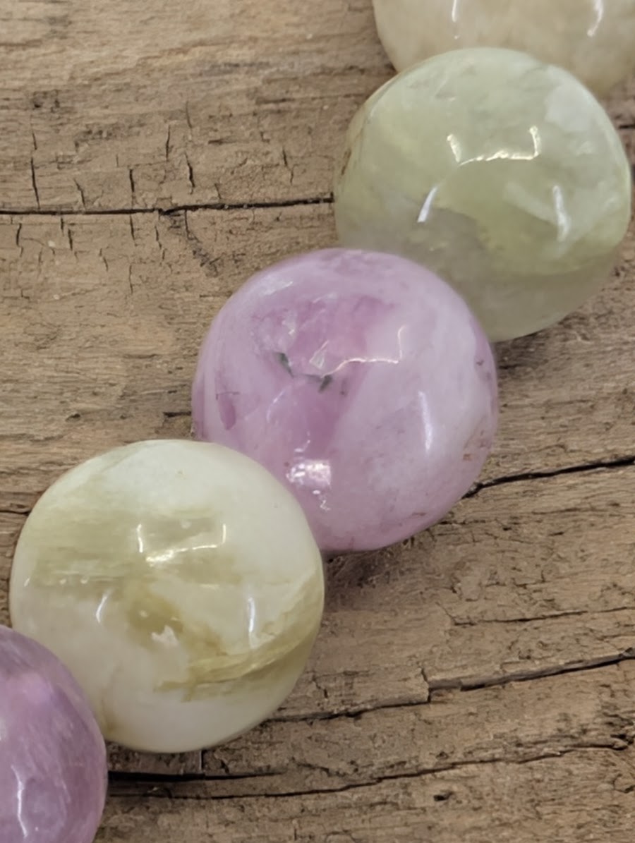 Macro shot of Brazilian mixed mica beads highlighting the silky chatoyant shimmer and natural internal structures.