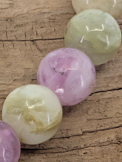 Macro shot of Brazilian mixed mica beads highlighting the silky chatoyant shimmer and natural internal structures.