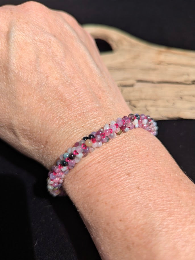 Hand-woven mixed Tourmaline beaded bracelet worn on a wrist for size scale.