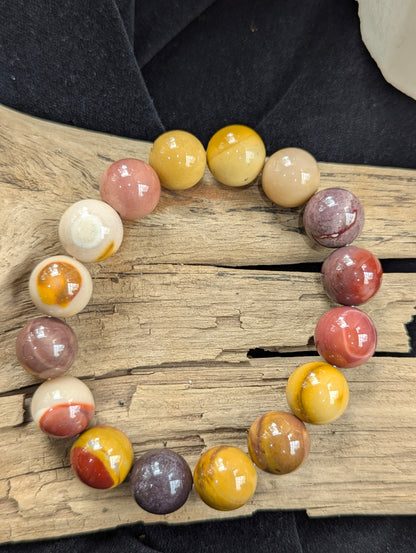 An oversized 12mm Mookaite bead statement bracelet from Western Australia perfectly balanced on a piece of natural driftwood.