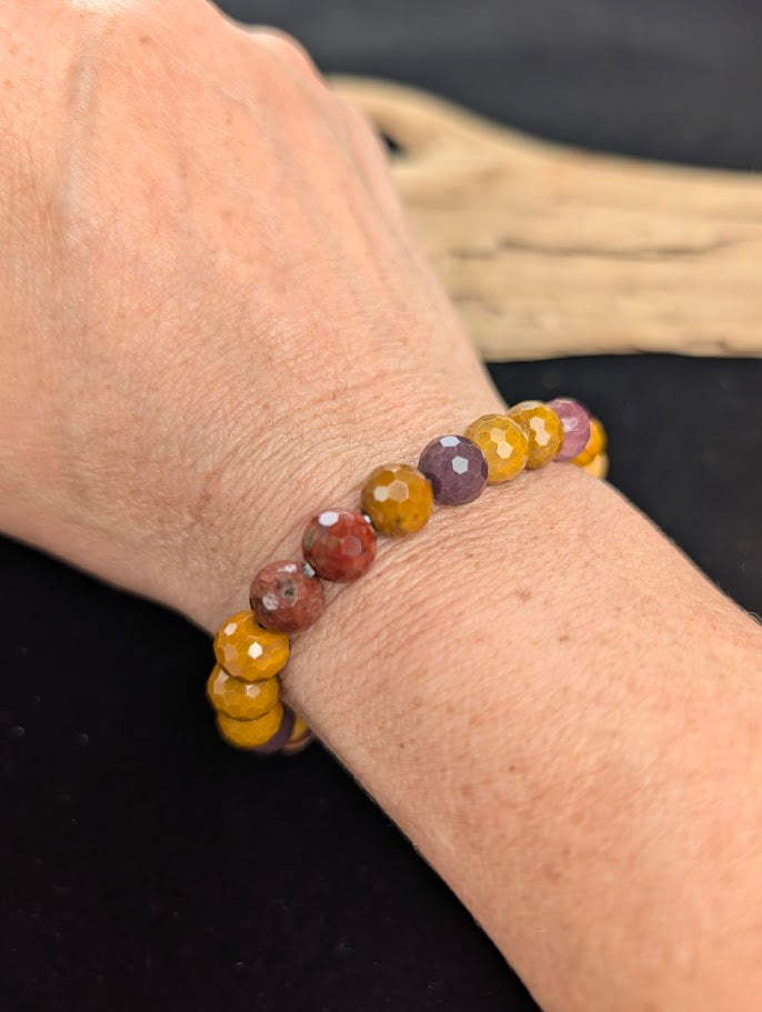 8mm faceted Mookaite beaded stretch b8mm faceted Mookaite beaded stretch bracelet worn on a wrist for size scale.racelet worn on a wrist for size scale.