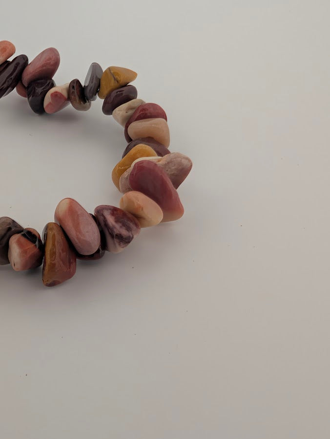 Detail of Mookaite chip bracelet with warm desert palette