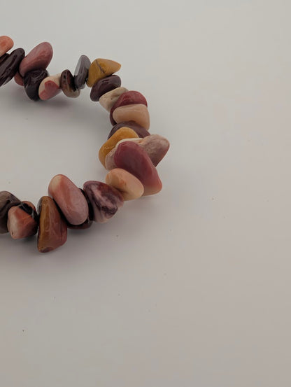 Detail of Mookaite chip bracelet with warm desert palette
