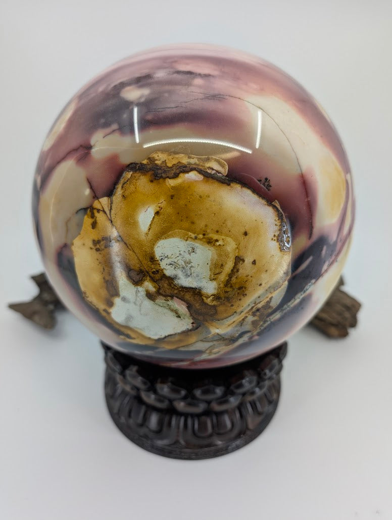 Close-up of the rare "eye" pattern formed by yellow brecciated sediment on a massive Mookaite sphere.