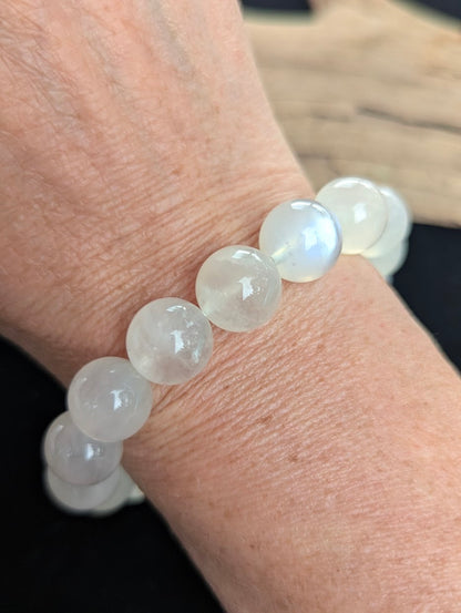 12mm cloudy white Sri Lankan Moonstone bracelet being worn on a wrist.