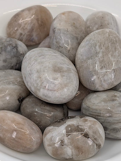 Close-up of Moonstone tumbled stones showing sheen and polish