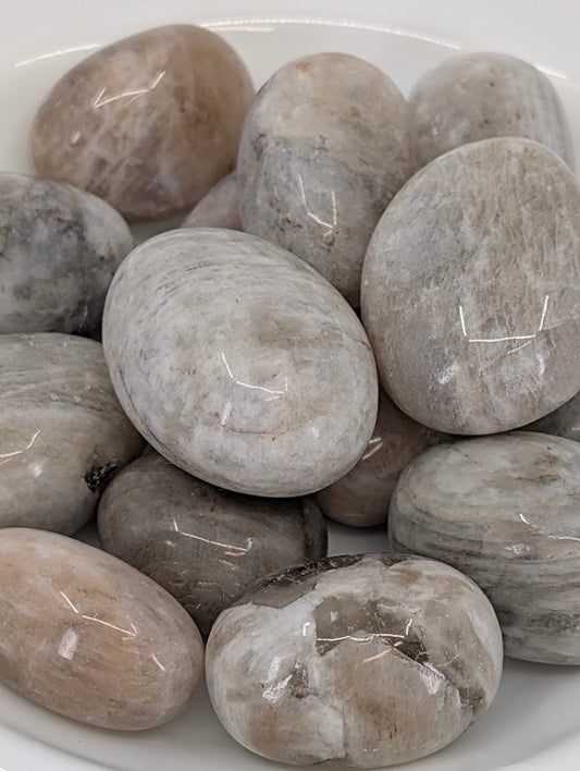Close-up of Moonstone tumbled stones showing sheen and polish