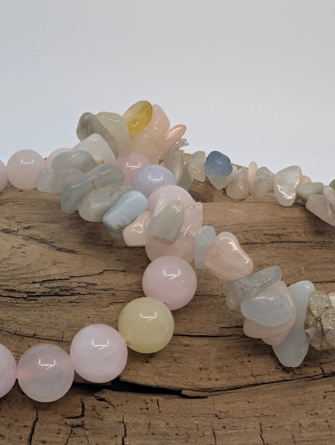 Close-up of morganite 8MM and chip bracelets showing blush, blue and honey hues