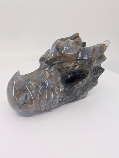 Side view of moss agate dragon head showing smoky chalcedony and moss patterns