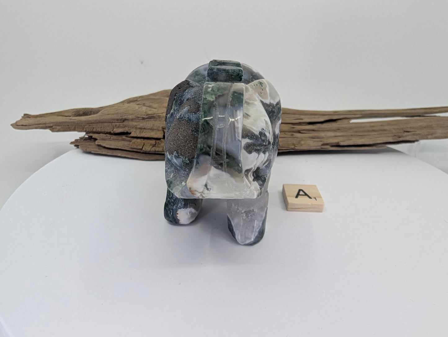 Front of Moss Agate elephant A showcasing dark green forest-like inclusions on white chalcedony.