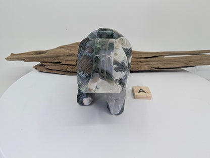 Front of Moss Agate elephant A showcasing dark green forest-like inclusions on white chalcedony.