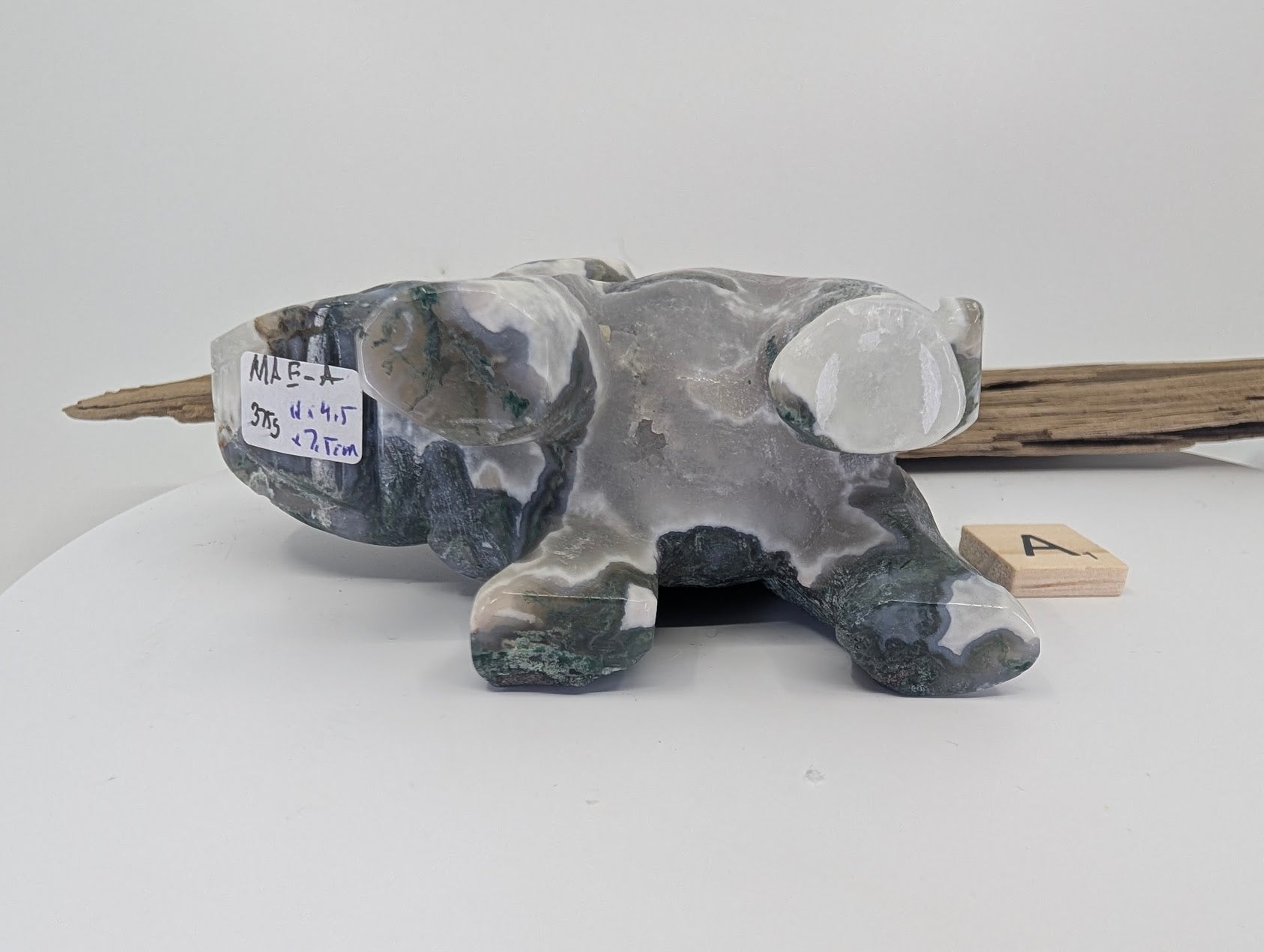 Hand-held view of Moss Agate elephant A showing scale and light transmission through the translucent chalcedony.