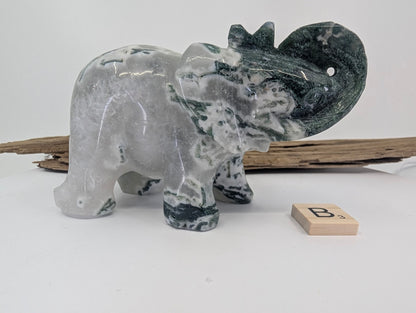 Profile of Moss Agate elephant B featuring translucent chalcedony and floating green moss inclusions