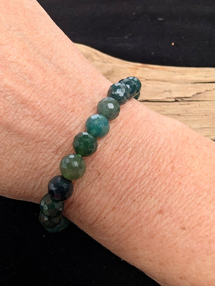 8mm faceted Moss Agate beaded stretch bracelet worn on a wrist for size scale.