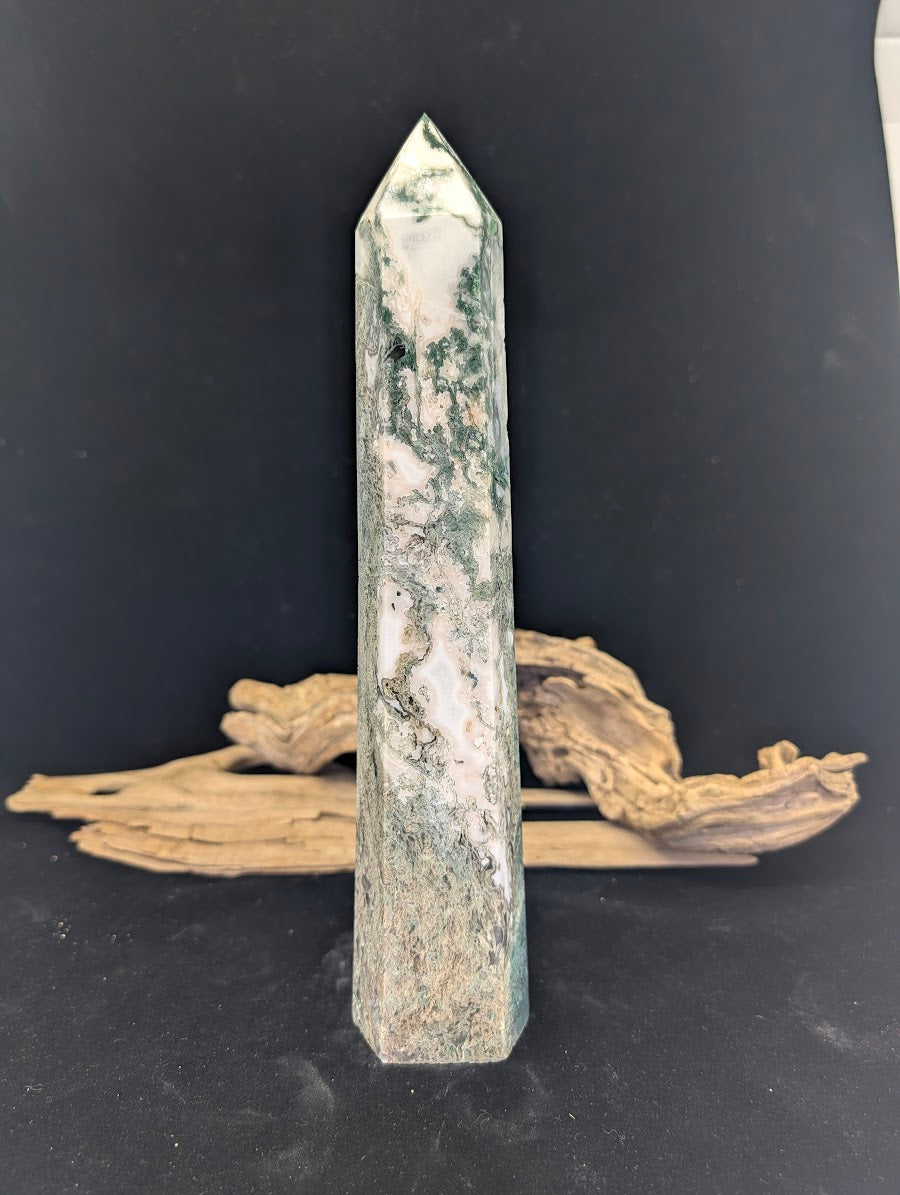 Reverse face of tower MA-03 showing consistent forest-green mineral growth throughout the stone.