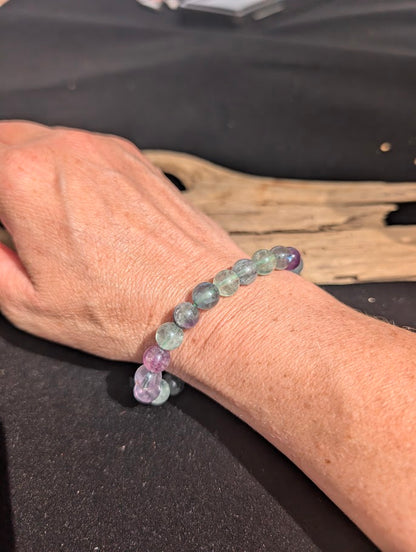 8mm multi-colour fluorite beaded stretch bracelet worn on a wrist for size scale.
