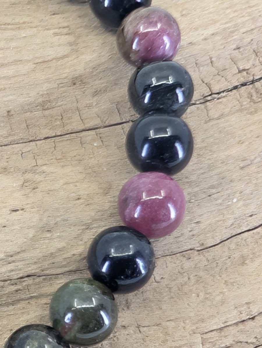 Macro view of Multi-Color Tourmaline beads showing professional mirror luster and authentic mineral inclusions.