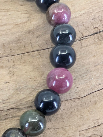 Macro view of Multi-Color Tourmaline beads showing professional mirror luster and authentic mineral inclusions.