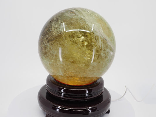 6.5 inch Natural Citrine sphere from Zambia on stand displaying honey gold color.