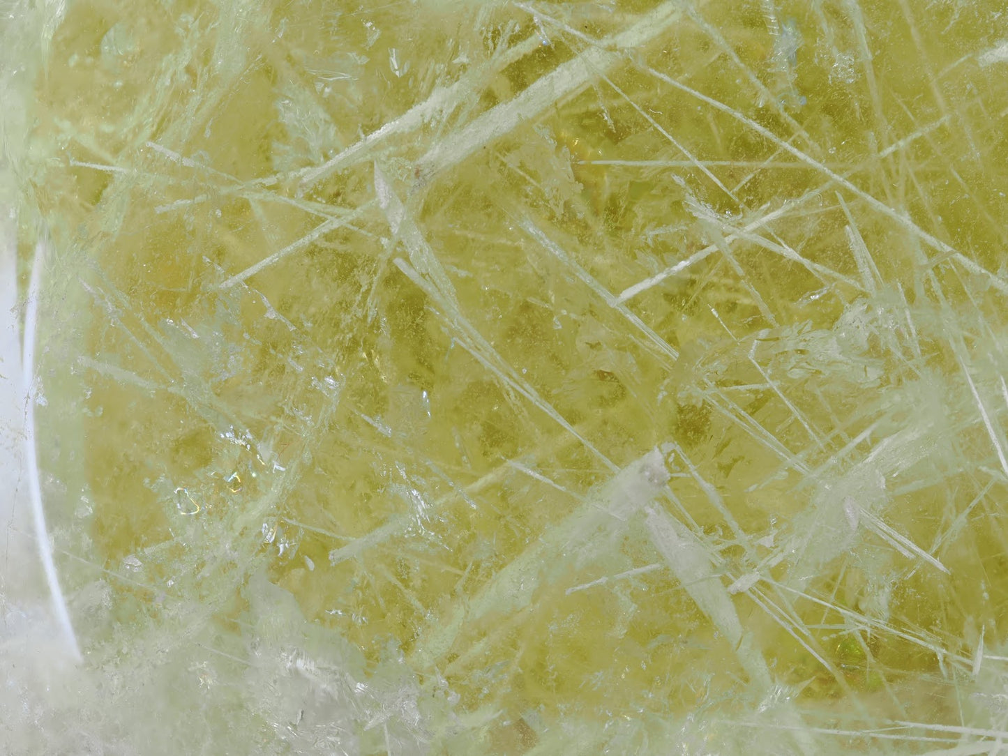 Extreme close up of snowflake goethite patterns inside natural yellow citrine.