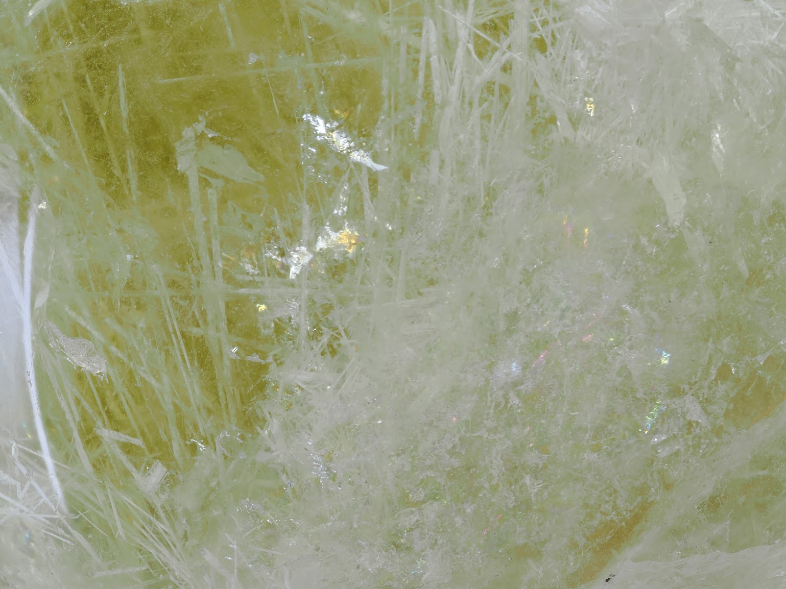 Microscopic detail of silver rutile sprays inside a museum grade citrine sphere.